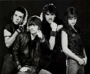 Strike Force in 1984 (l. to r.): Mike Pitre (v,k,g), Pete Paillé (v,d), Mario LeBlanc (v,b), Romy Bélanger (v,g)